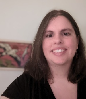 professor wearing a black shirt in front of a white backdrop